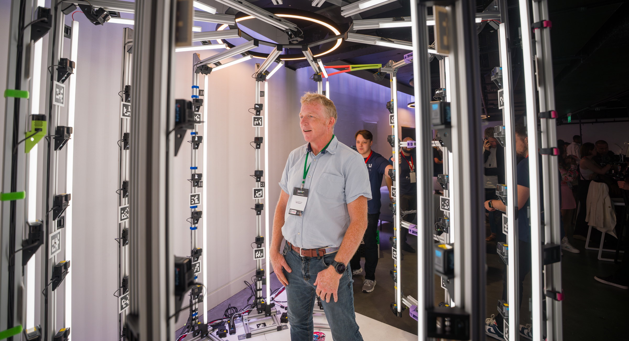 An expo visitor stepping inside the Figured You scanning rig