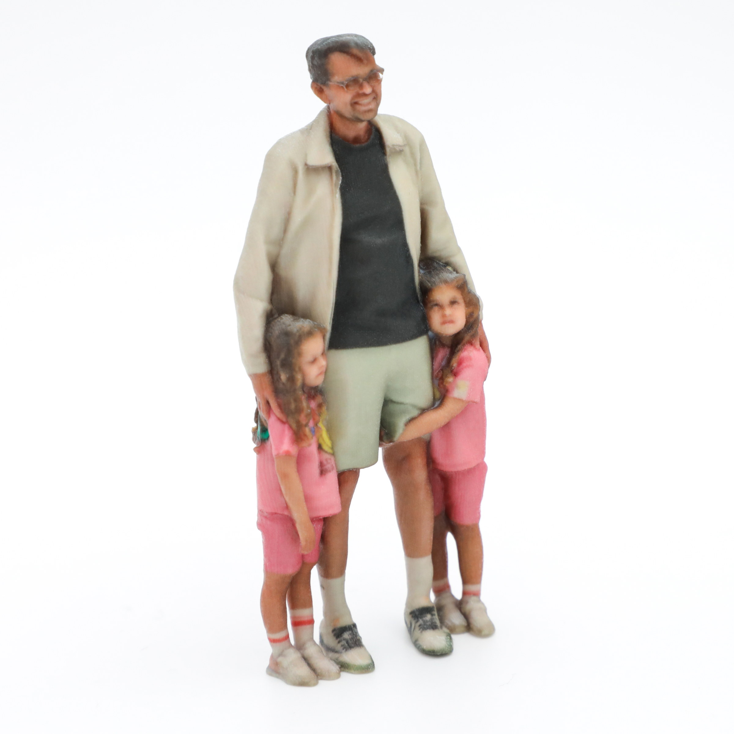 A dad and his twin daughters captured together as a 3D printed figurine
