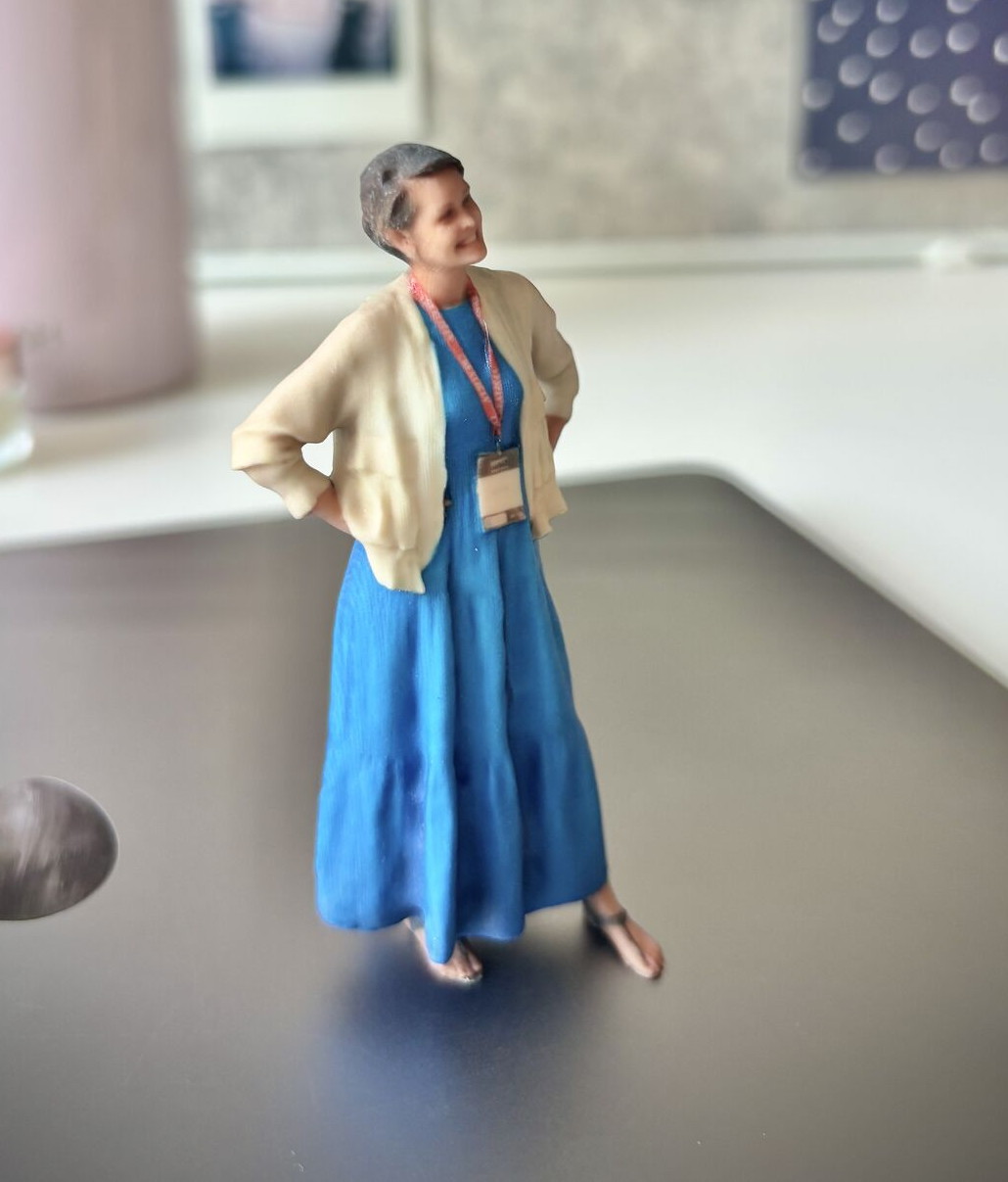 A 3D printed figurine of a colleague standing on an office desk
