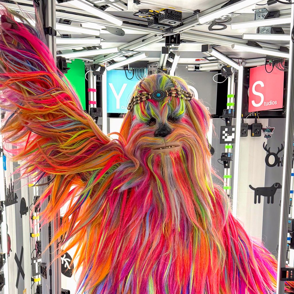 A giant rainbow-coloured costume being scanned inside the Figured You rig