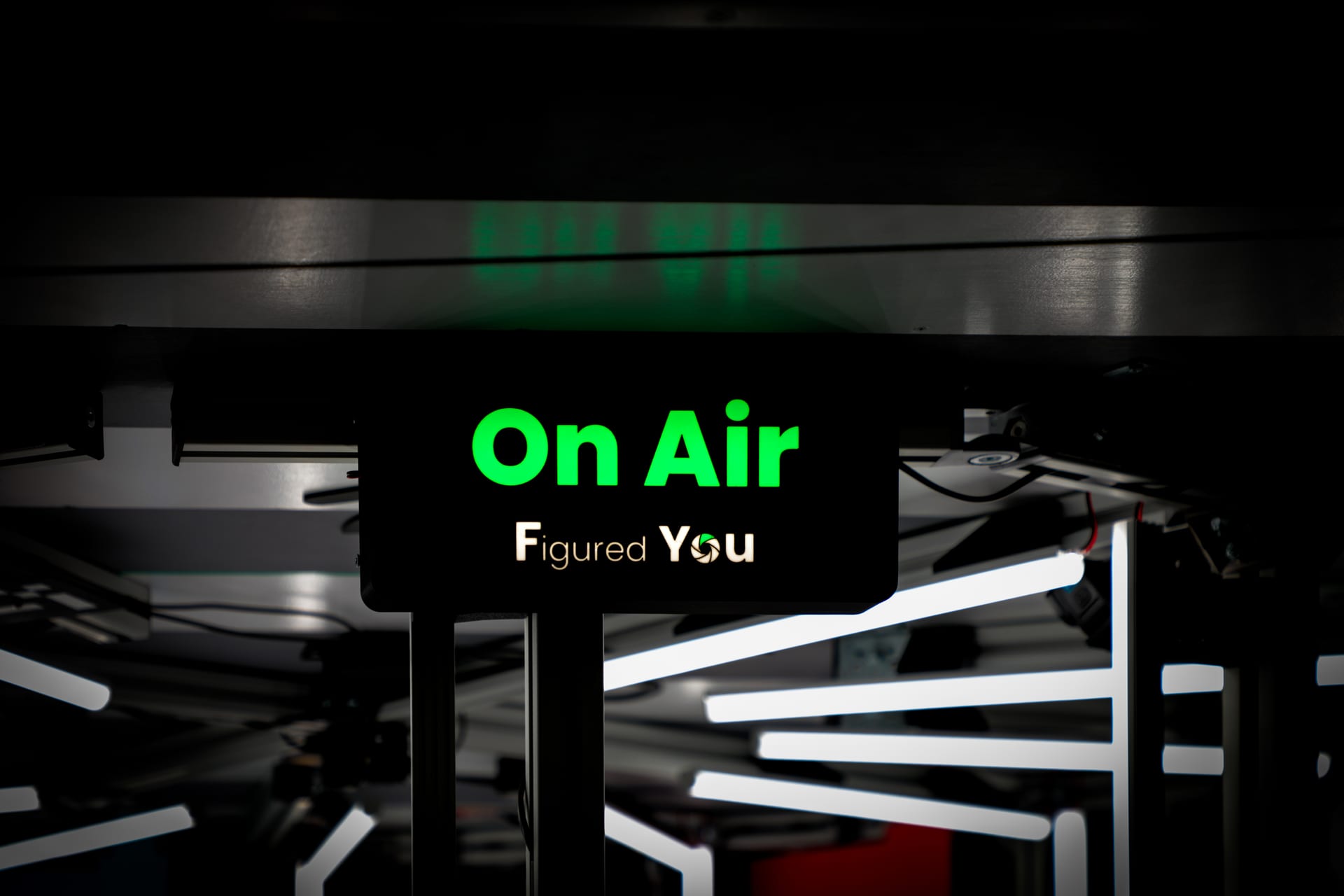 The On Air sign glowing inside the studio
