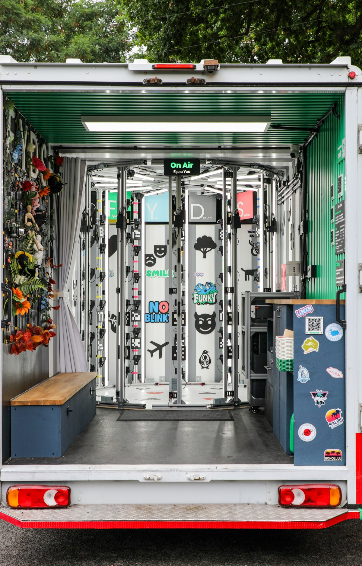 The rear of the Figured You studio van with its doors open and the scanning rig visible inside